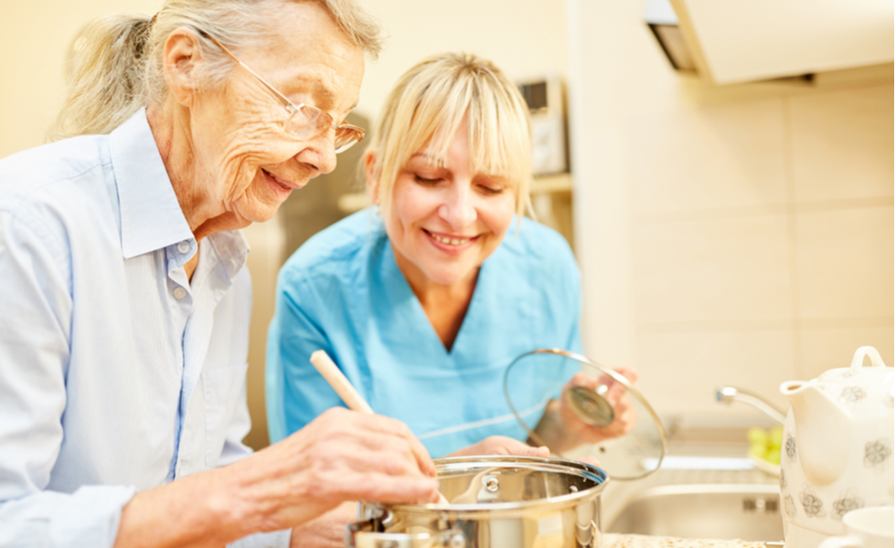 caregiver assisting senior with meal preparation